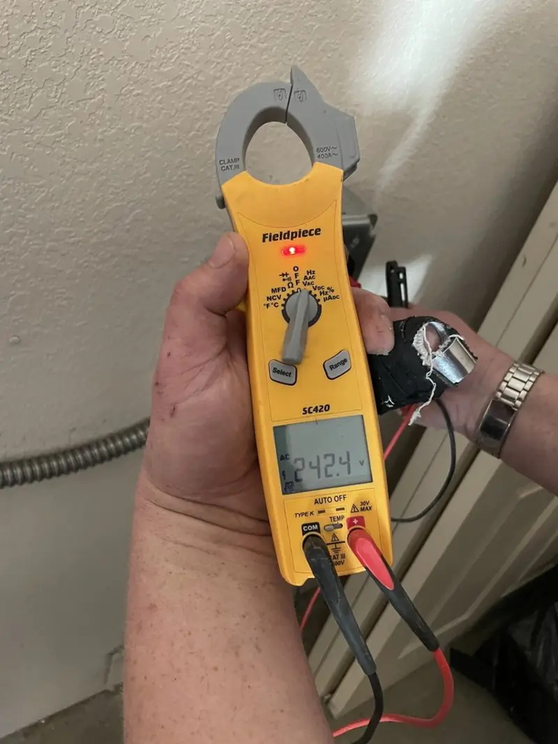 Voltage testing with clamp meter during Electrical Installation Services in Tice